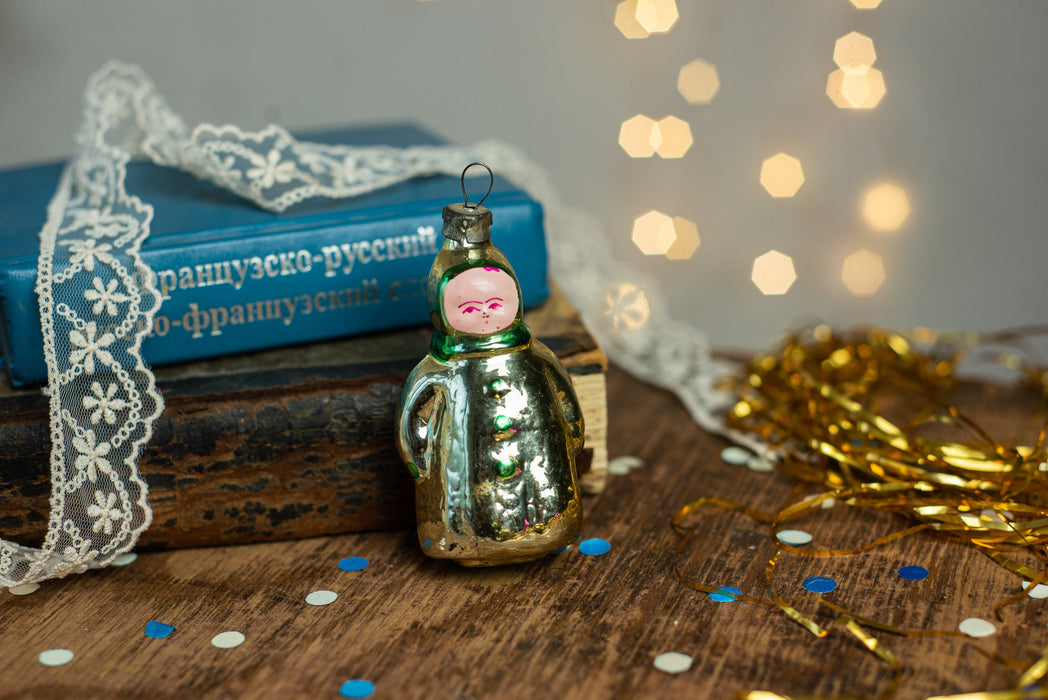 Girl Christmas glass ornament, winter child in a coat