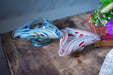 two glass bowls with colorful, swirling patterns on a wooden surface.
