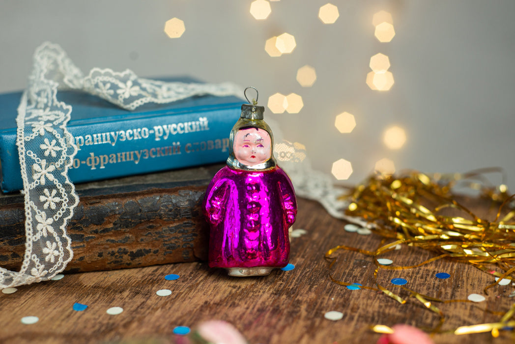 Girl Christmas glass ornament, winter child in a coat