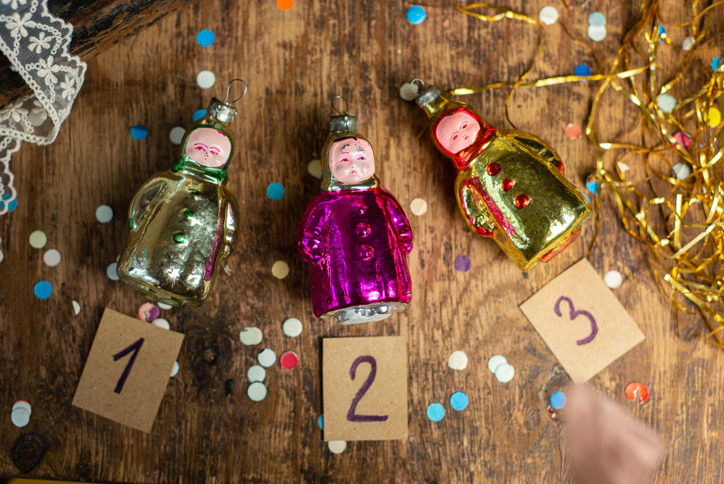 Girl Christmas glass ornament, winter child in a coat