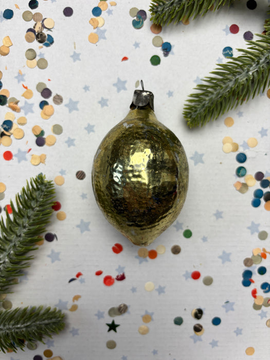 a shiny gold ornament, a pine branch, and colorful confetti on a white background.