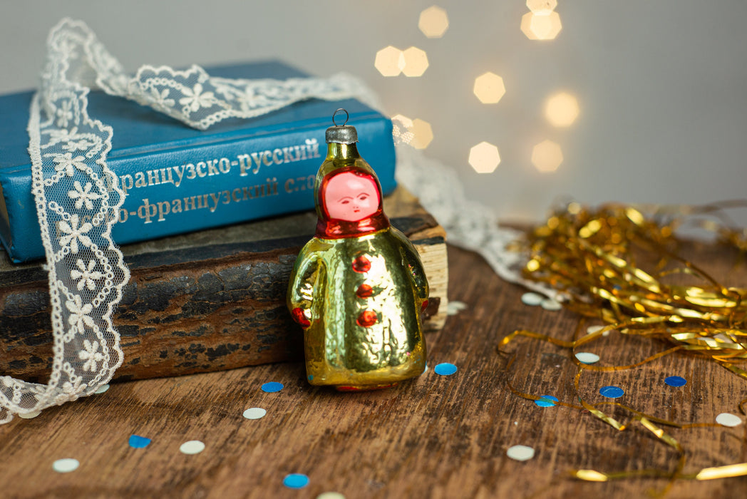 Girl Christmas glass ornament, winter child in a coat